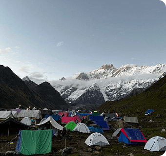 Tents pitched at a Karakoram basecamp beneath snow peaks